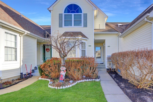 doorway to property featuring a lawn