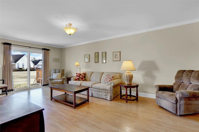 living room featuring crown molding and light hardwood / wood-style floors