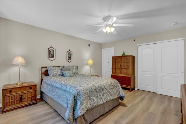 bedroom featuring ceiling fan, a closet, and light hardwood / wood-style flooring