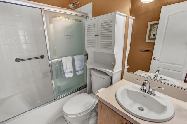 full bathroom with toilet, bath / shower combo with glass door, and vanity