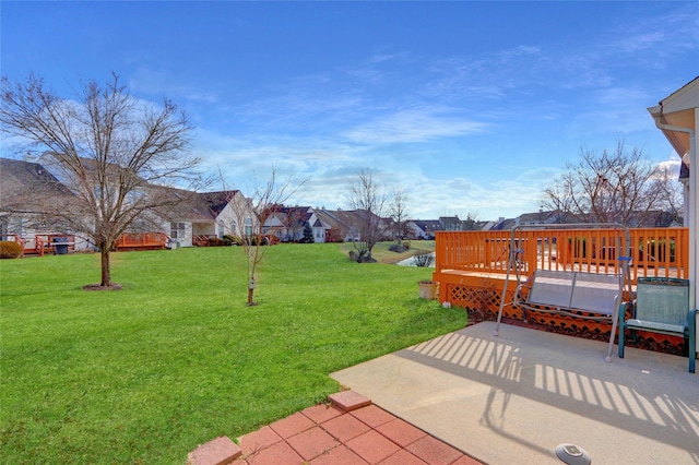 view of yard with a deck and a patio