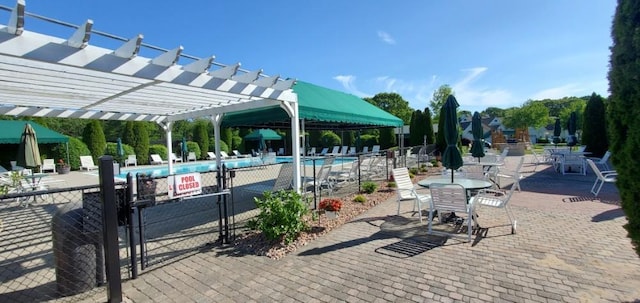 view of community with a pergola, a patio area, and a pool