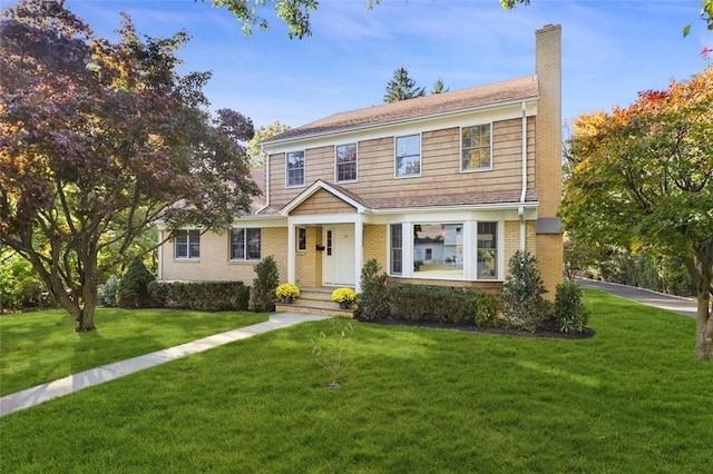 colonial inspired home with a front lawn