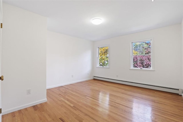 spare room featuring light hardwood / wood-style floors and baseboard heating