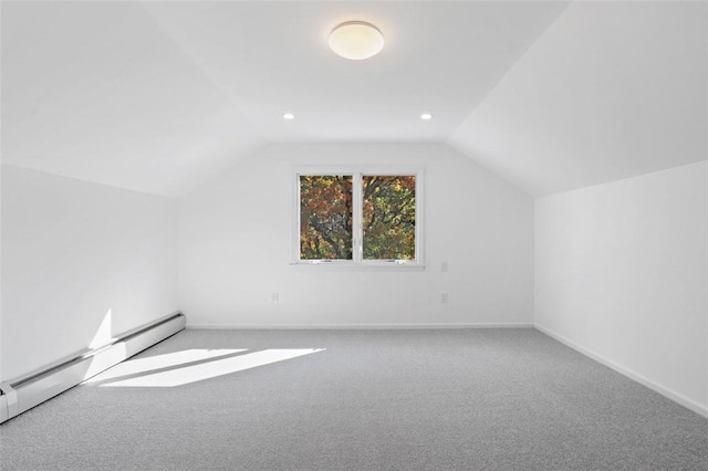 additional living space with carpet floors, a baseboard radiator, and vaulted ceiling