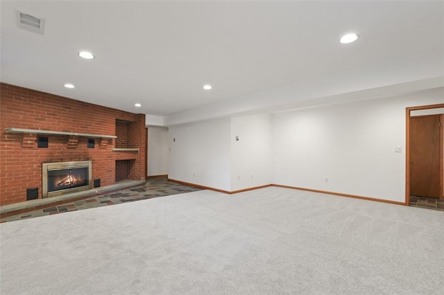 unfurnished living room with a brick fireplace and carpet flooring