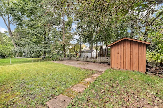 view of yard featuring a shed and a patio