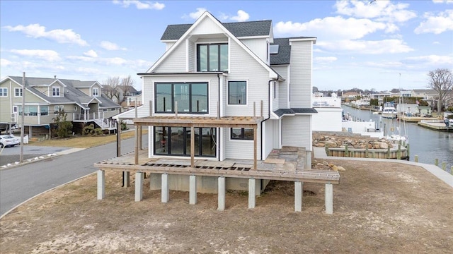 rear view of property featuring a water view