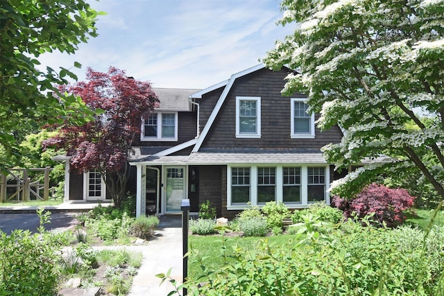 view of front of home featuring roof with shingles and a gambrel roof