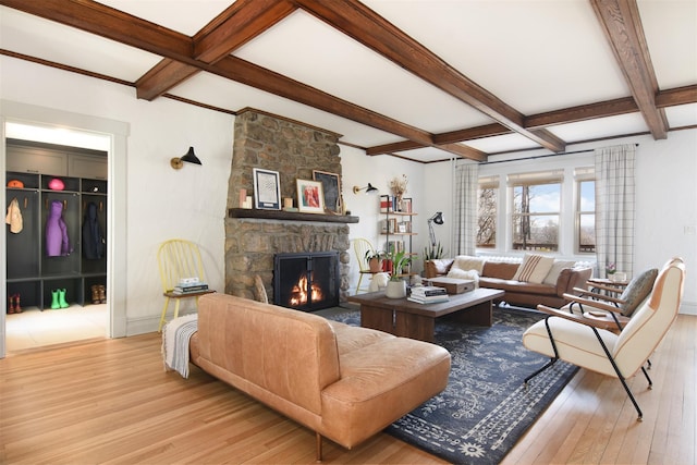 living area featuring hardwood / wood-style flooring, a fireplace, coffered ceiling, and beamed ceiling