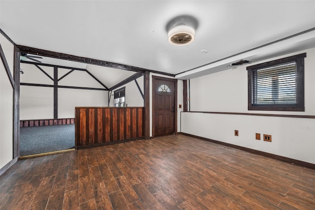 interior space with dark wood-type flooring and vaulted ceiling