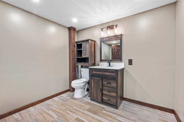 bathroom featuring vanity, hardwood / wood-style floors, and toilet