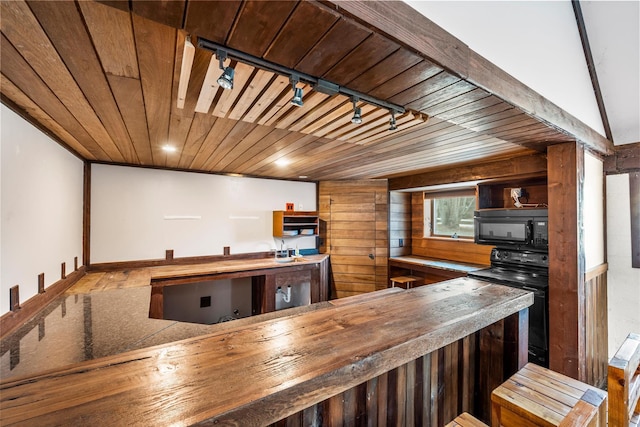 kitchen with butcher block counters, wood ceiling, black appliances, and rail lighting