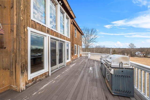 wooden terrace with a grill