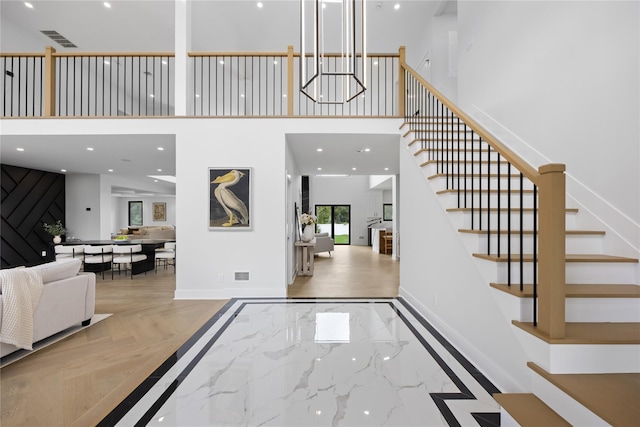 foyer entrance with a towering ceiling