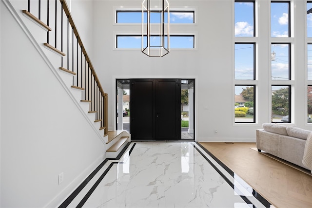 entrance foyer with a notable chandelier and a high ceiling