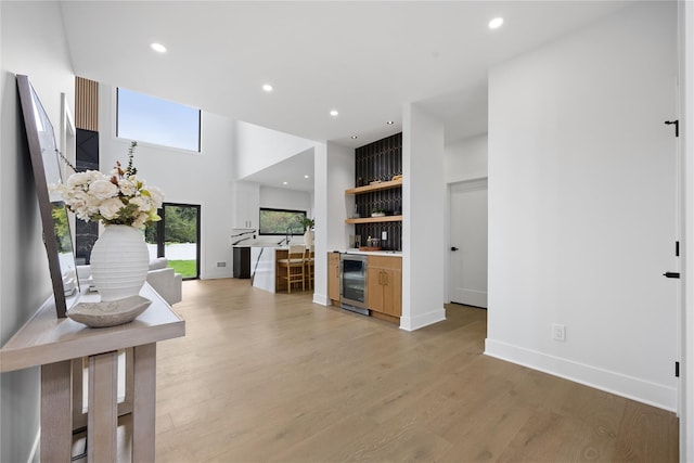 living room featuring beverage cooler and light hardwood / wood-style floors