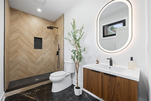 bathroom with toilet, a shower, and vanity