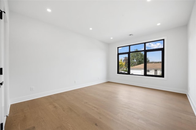 spare room featuring light hardwood / wood-style flooring