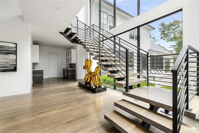 stairs featuring hardwood / wood-style flooring