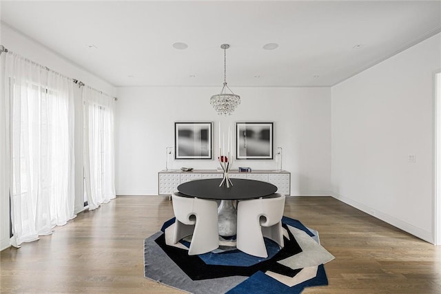 dining room with a notable chandelier and dark hardwood / wood-style floors