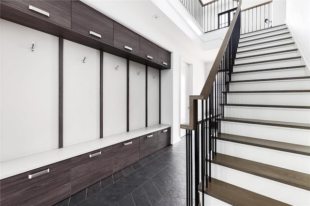 mudroom featuring dark tile patterned flooring