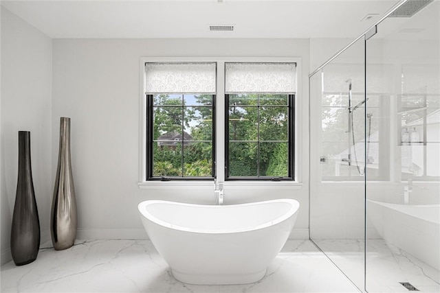 bathroom with plus walk in shower and a wealth of natural light