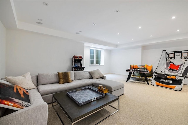 living room featuring carpet floors and a tray ceiling