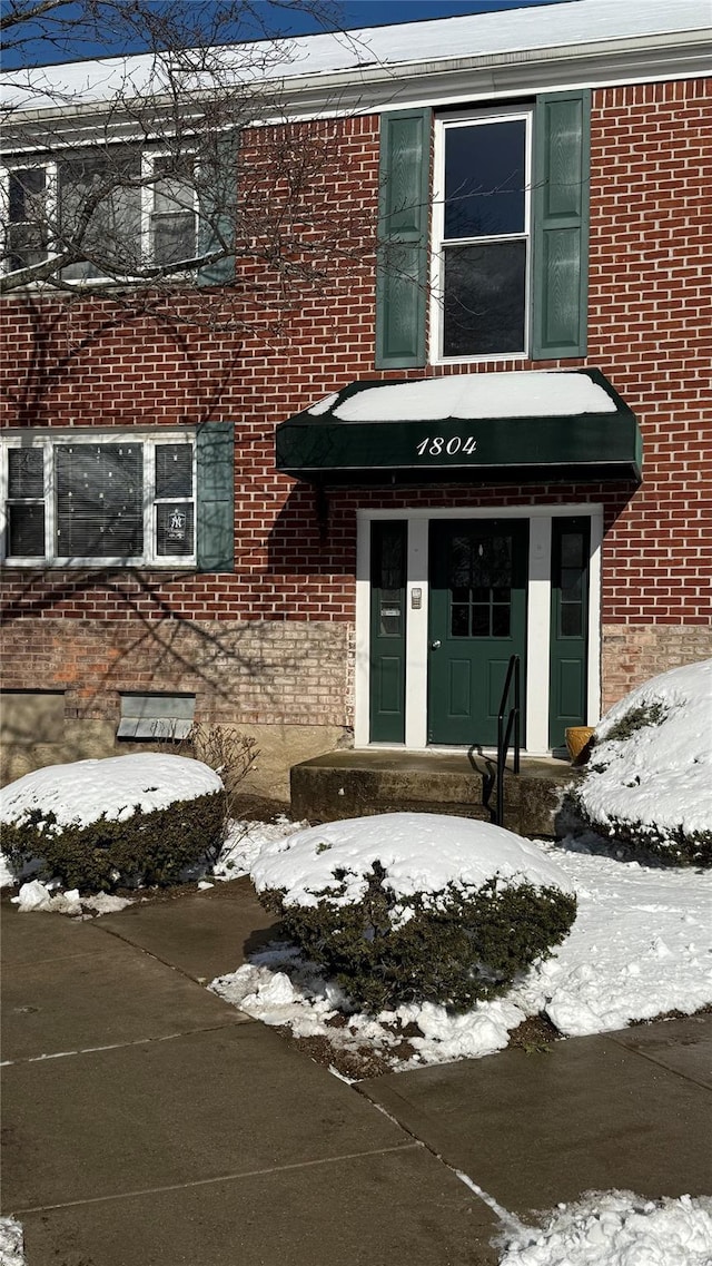 view of snow covered property entrance