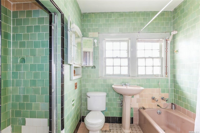 bathroom featuring toilet and tile walls