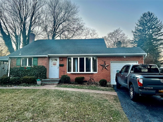 single story home with a front yard and a garage