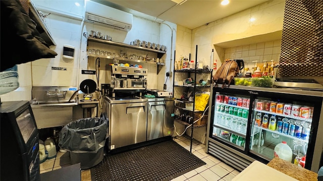 bar with light tile patterned flooring, a wall unit AC, tasteful backsplash, and stainless steel counters