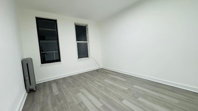 spare room featuring light hardwood / wood-style flooring