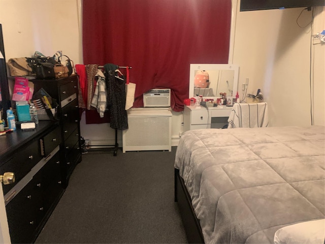 bedroom featuring an AC wall unit and dark colored carpet