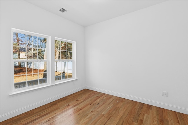 spare room with hardwood / wood-style flooring