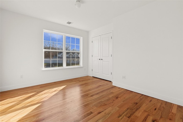 spare room with light hardwood / wood-style flooring