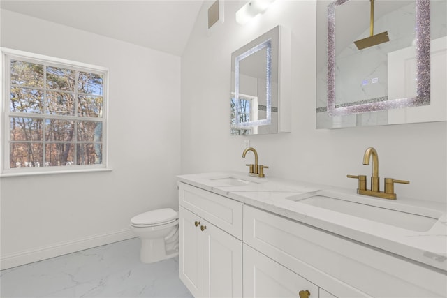 bathroom featuring toilet, vaulted ceiling, and vanity