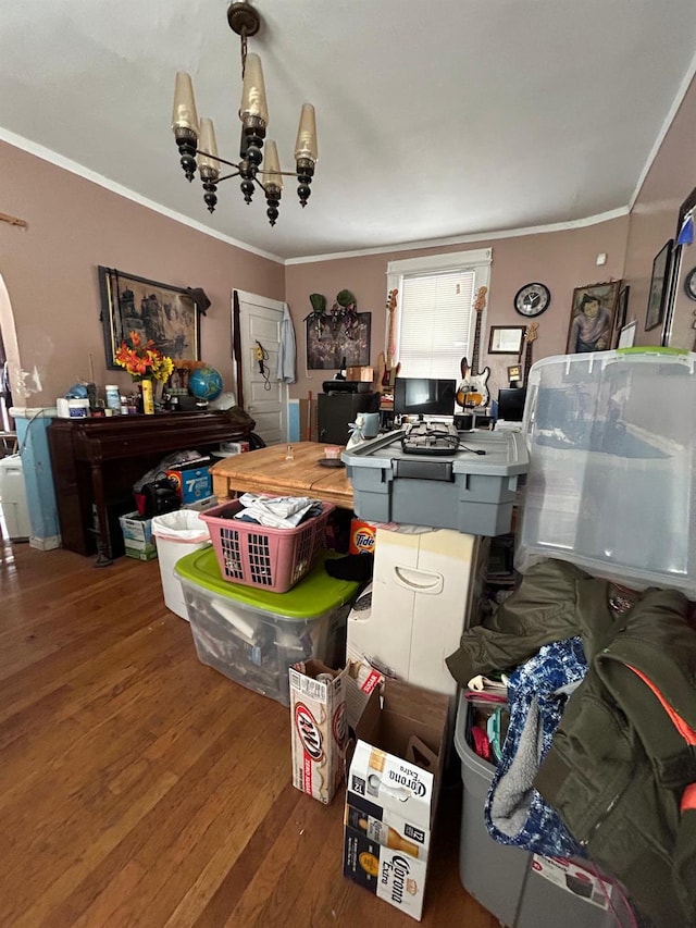 interior space with hardwood / wood-style floors, an inviting chandelier, and ornamental molding