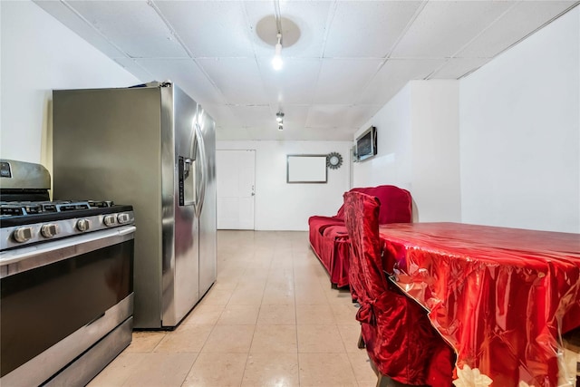 kitchen with a paneled ceiling and gas stove