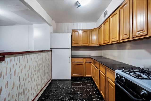 kitchen with white fridge and gas stove