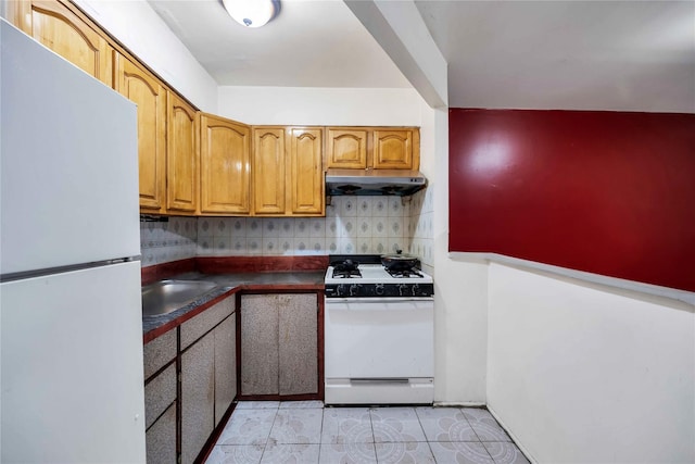 kitchen featuring white appliances, sink, decorative backsplash, and light tile patterned floors