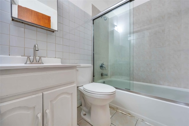 full bathroom with toilet, enclosed tub / shower combo, vanity, tile walls, and backsplash