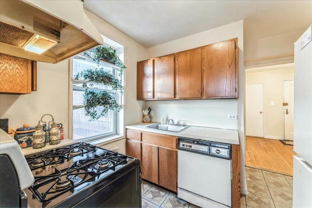 kitchen featuring extractor fan, gas stove, white dishwasher, a wealth of natural light, and sink