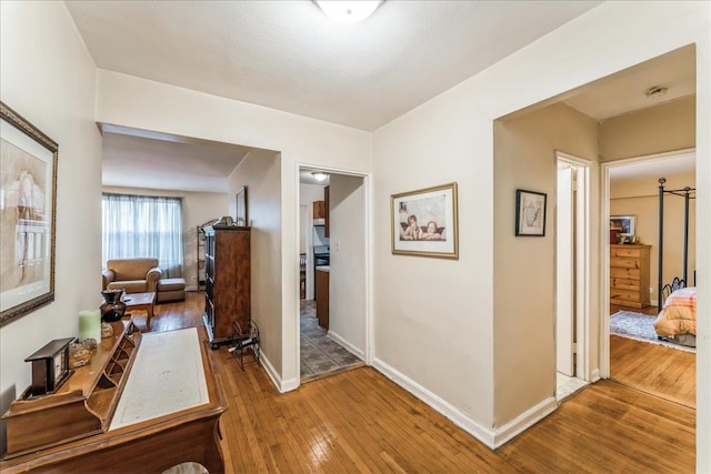 corridor with hardwood / wood-style floors