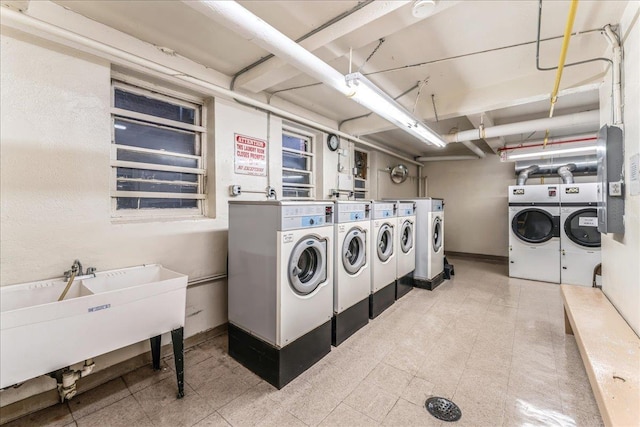 washroom featuring washer and dryer and sink