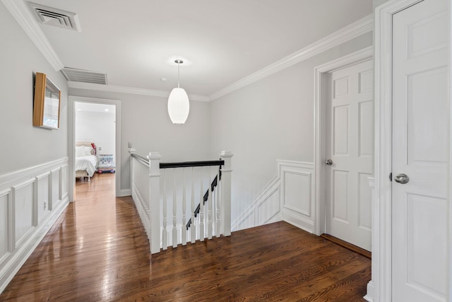 hallway with dark hardwood / wood-style floors and ornamental molding