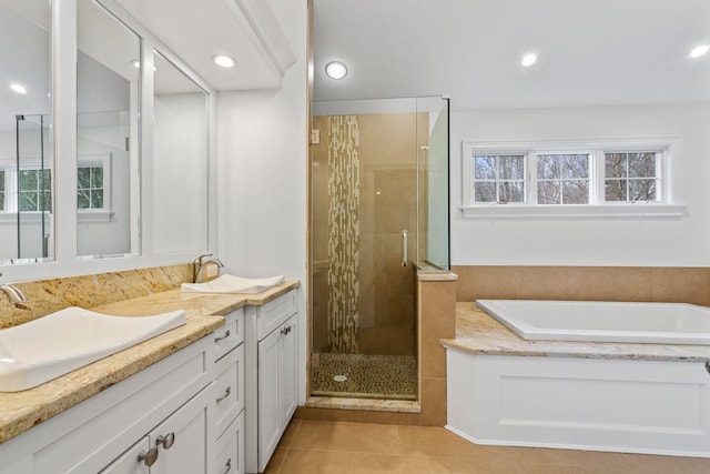 bathroom featuring a wealth of natural light, tile patterned floors, separate shower and tub, and vanity