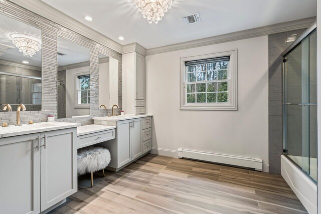 bathroom with vanity, combined bath / shower with glass door, decorative backsplash, an inviting chandelier, and a baseboard radiator