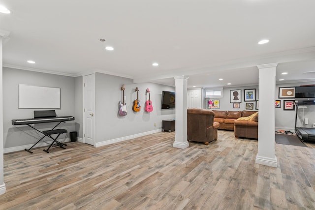 living room featuring light wood-type flooring, ornamental molding, and ornate columns