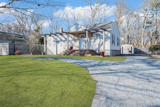 view of front facade with a pergola, a shed, and a front lawn